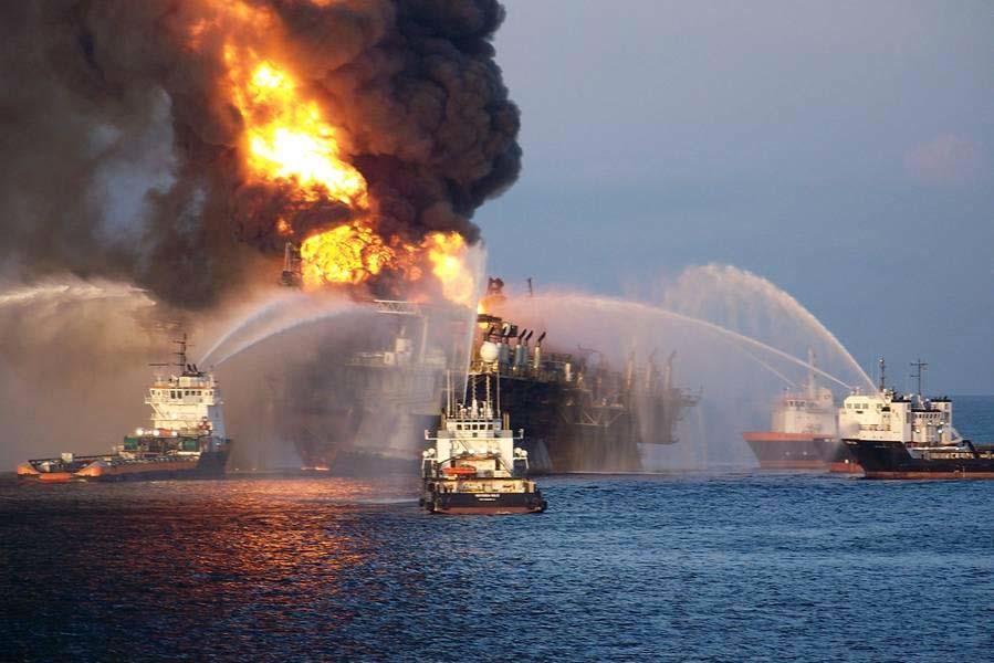 Support vessels using their fire fighting gear to cool the rig note the list developing