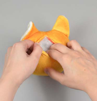 Insert the needle from the inside of the opening and out of the plush near one edge of the opening.