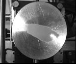 The glass plate position was adjusted with a micrometer to get maximum resonance in the air, as determined by particle levitation.