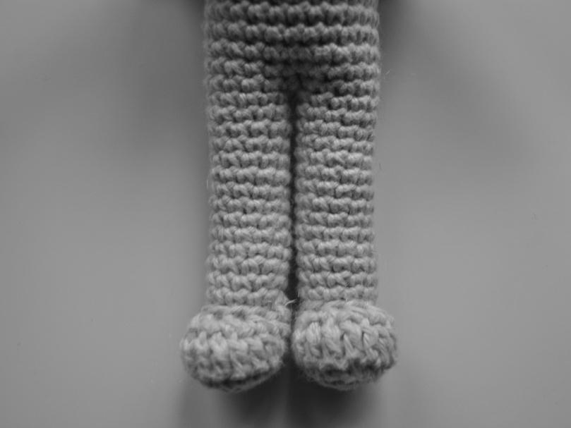 Continue crocheting around one half of the body to form a leg and fasten off.
