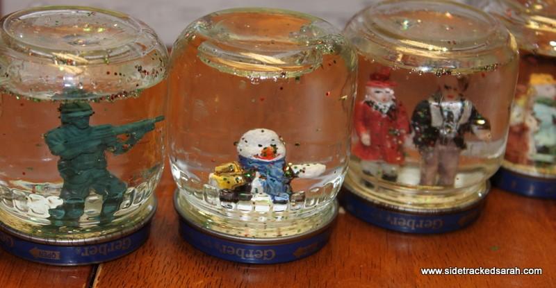 Day 16 Christmas Snow Globe Supplies: Small baby food jar with lid Glue Gun Small Toys or ornaments that fit into the jar Water Glitter ¼ ribbon