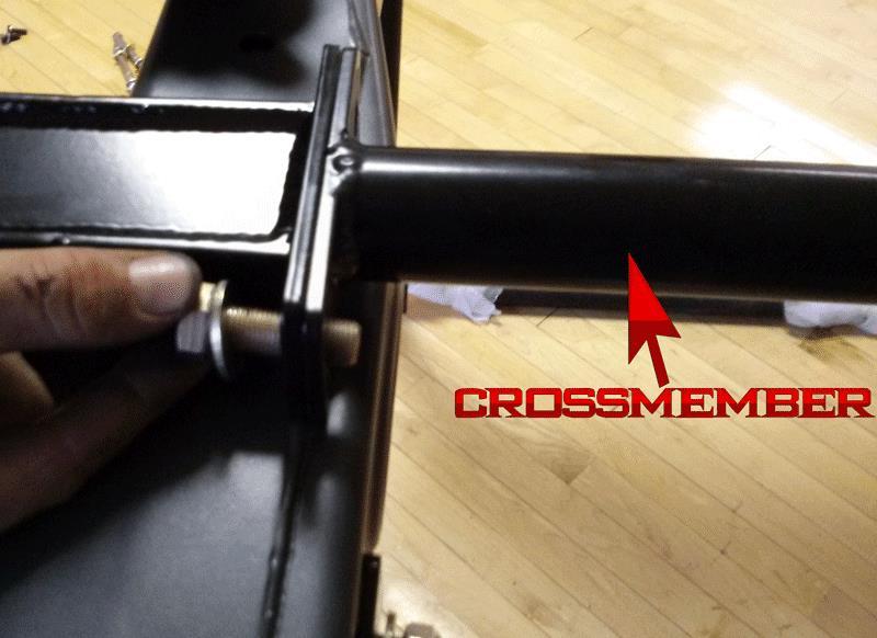 6. Locate the 1-1/2 tube cross member. Slide the tube up over the exhaust and on top of the frame rail.