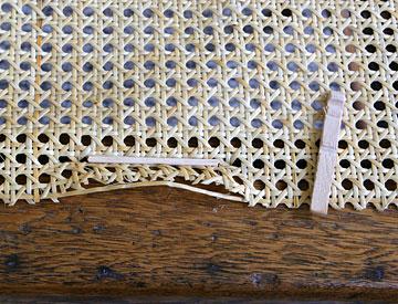 Stretch the webbing across the opening and center it over the opening (shiny side of cane webbing up).
