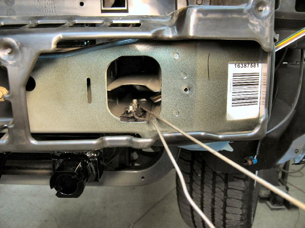 Using a 10MM socket, remove the metric nuts securing the frame rail cup to the frame. Do this to both sides of the vehicle.