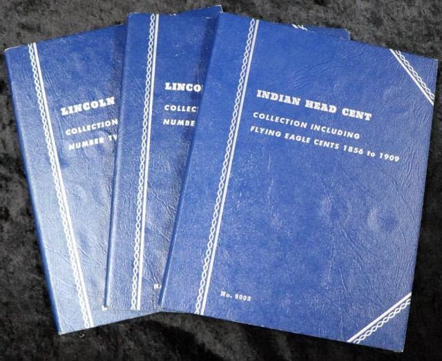 blue colored collection books; Indian Head with 12 coins,