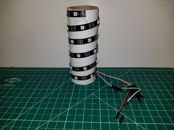 Step 2: Assembly First, take the brown film off the back of the LED strip and attach it to the cylinder in a spiral shape as shown.