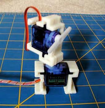 Figure 9-7. Mount one servo on top of the other (image by David Stokes) The joystick can be purchased from ebay or an electrical supplier. You could also find an old C64 or Atari joystick.