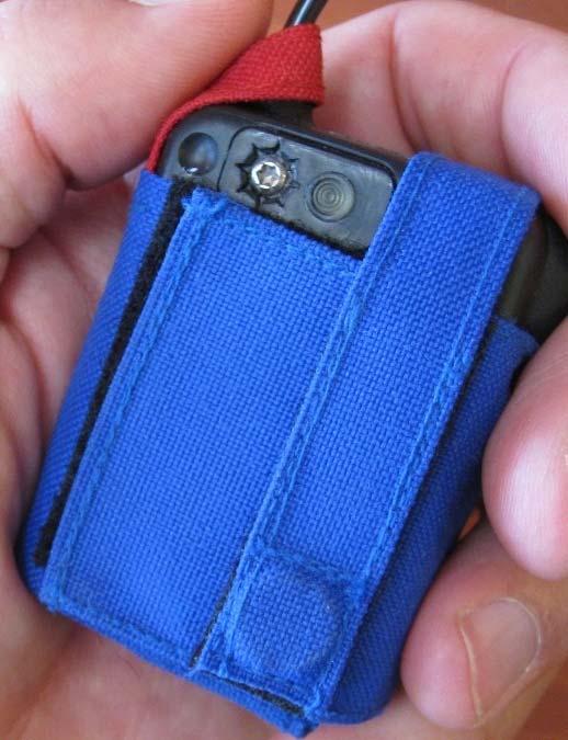 Option 2: If transmitter is being worn in the blue nylon pouch provided (see figure 3), release the securing strap and align the embedded magnet with the round recess for 3 seconds until the DML