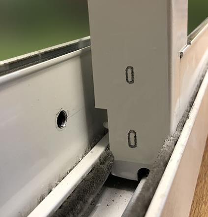 With the bolt extended and inserted into the drilled hole, position the Vacation Lock onto edge of your sliding glass door