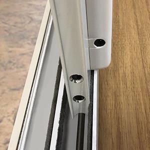 bottom of your door track so that the Simi-circular groves in the pet door Bottom Panel are placed over the sliding rail at