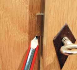 Fitting escutcheon Lightly mark the vertical centre line of the keyhole, then place the escutcheon over it and insert the key to aid positioning.