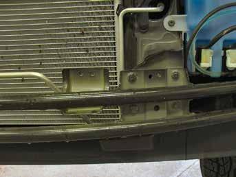 Using a 12MM socket, remove four metric bolts from the metal bumper. Do this to both sides of the vehicle.