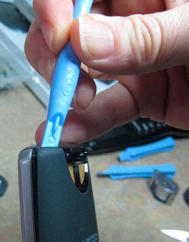 To remove the sticker, use an x-acto blade or razor to get underneath one of the corners and peel it up gently. Once you get it started, you can use tweezers or small pliers to peel it off.