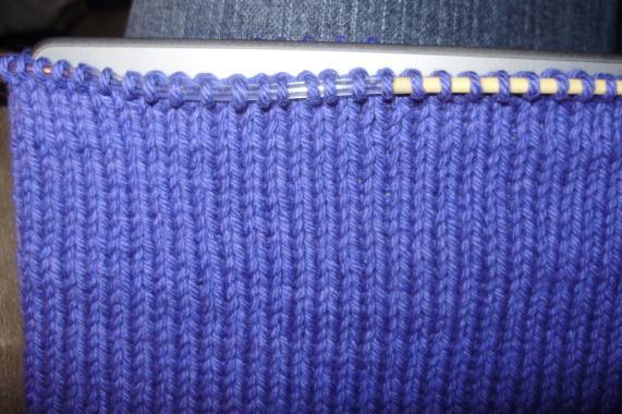 See here the bound off edge of one side: Turn the cover so you are working on the needle which still has stitches.