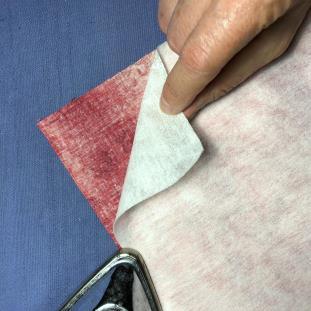 Apply the firm-weight fusible interfacing to the back side of the lining fabric, following the interfacing