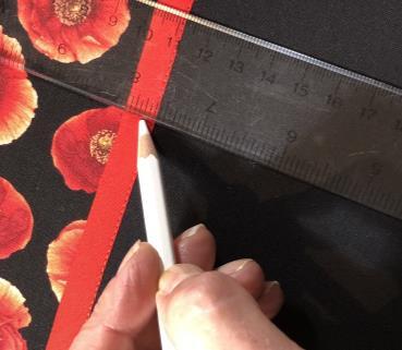 8. Pin the prepared pocket unit to the top of the main mat fabric front, with