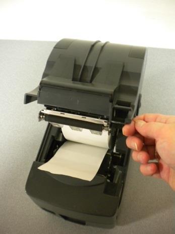 Unroll enough paper so that an inch or two of the paper protrudes out of the printer.