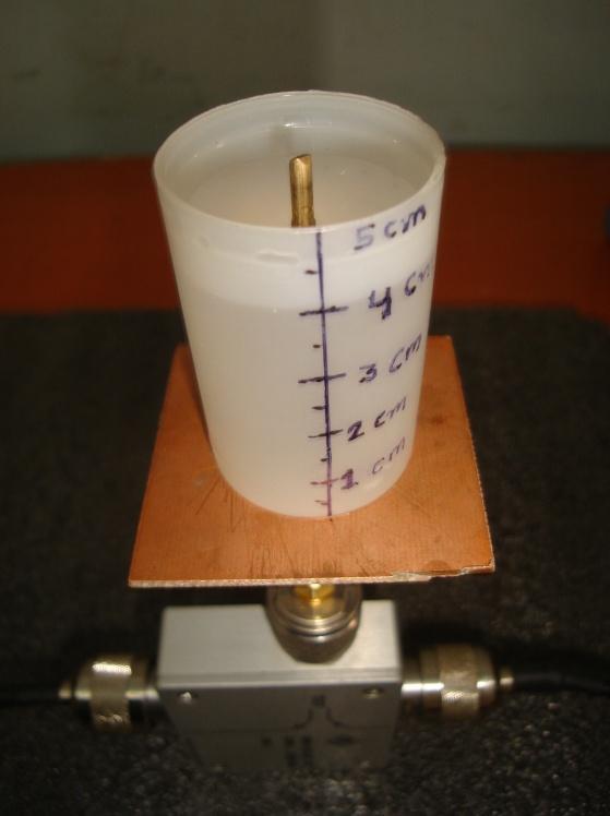 A fixed antenna length 50 mm height was concerned. Fig. 4 Photograph of monopole antenna with 4 cm liquid The frequency of monopole antenna was tuned 1.606 GHz at 0.5 M salinity with 21.