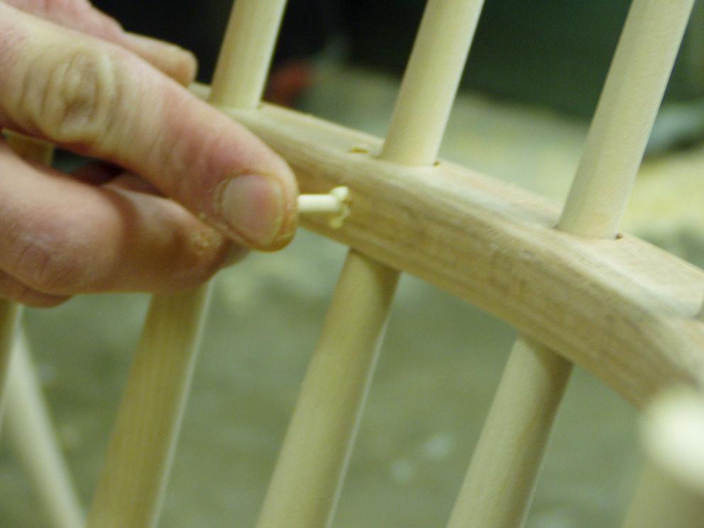 Slide the arm down over the spindles, lining the spindles into the proper holes on the way down.