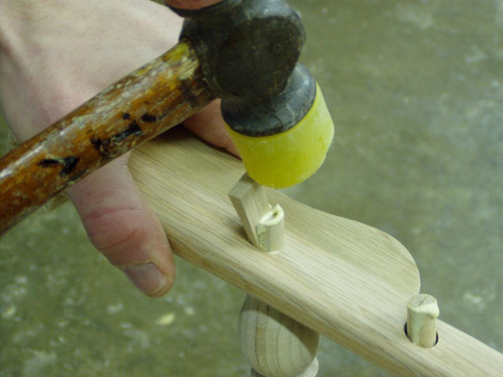 Use the hammer to drive the chisel into the post and split the top of each post. Split both post and what ever short spindles you have.
