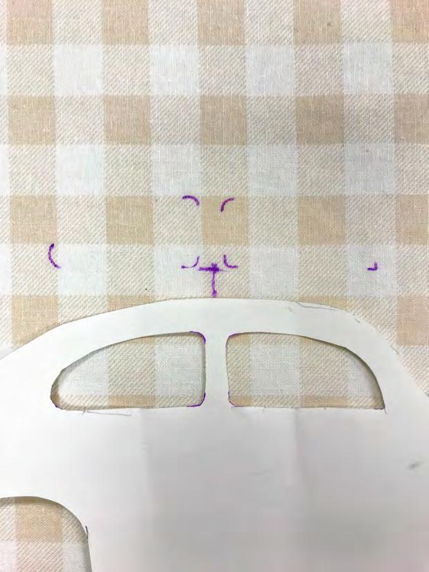 Using your ruler, find the center of the 20 (50.8cm) x 15 (31cm) piece and mark it with your fabric marking pen. 4. Center the Car Template on this mark, text side up.