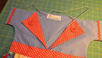 Optional: Sew buttons in the corner of each collar, and if you have a label