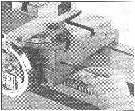 The large setscrew in the middle is used to lock the cross slide in place during machining operations. Before adjusting the gib screws, loosen this setscrew. Figure 30.