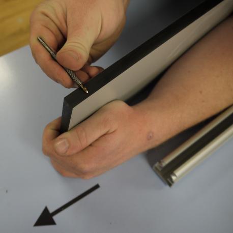 This image shows the length of the bit being set against the panel.