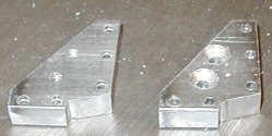 A piece of flat stock of the appropriate width was clamped into the angle as a saw guide. Each angle was then clamped into the mill and the edge finished to the proper leg width.
