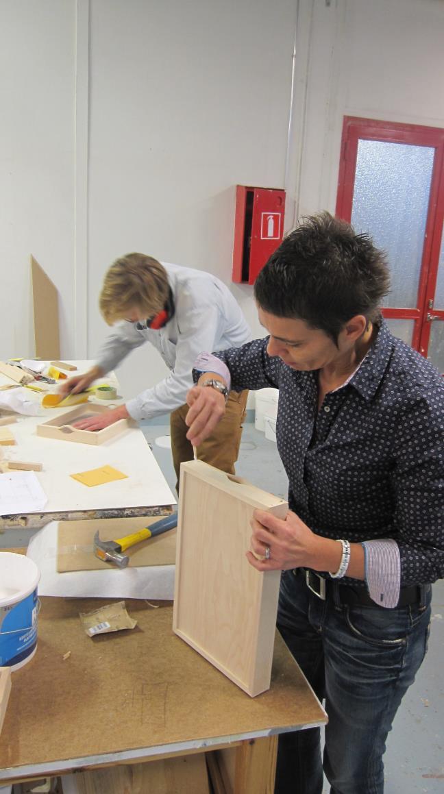 Isabelle, the French teacher, is gluing the dowels, and Niels,