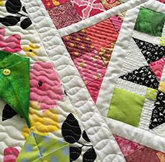 This quilted table centerpiece is chocked full of varied techniques featuring scraps and 9-patch block variations.