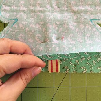Your pen marking will be your sew line, do not cut on this line! Use a scissors to cut ¼ inch around your sew line. Follow these steps using two sheets of Insul-Bright to cut your lining.