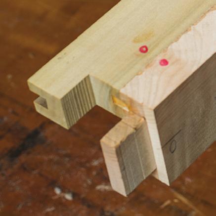 Then clamp a square across the bottom rail at the proper offset to center your bit on the layout.