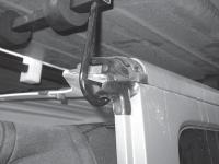 Top sections are unlatched and rolled back onto the hoist foam painted side down Pulley and hook attaches tto the eyebolt in the ceiling, see Fig. 7. Hook attaches to the Hoist Frame.