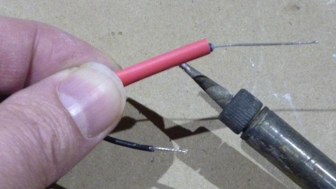 Slide the soldering iron back and forth over the length of the heat shrink tubing as you work your way around the
