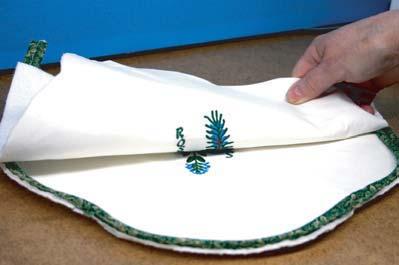 Place the other embroidered piece on top of the one with the piping, right sides together. Pin together for stability.