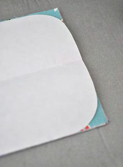Place the template on one end of the outer fabric and cut around the flap end. Repeat with lining fabric.