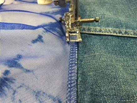 6) Measure around the bottom edge of the jean jacket and jot down that measurement. Cut the serged piece 4 larger than that measurement.
