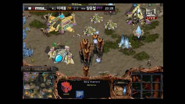 Jaedong brings in about 8 overlords to drop on Snow's 9 o'clock base.