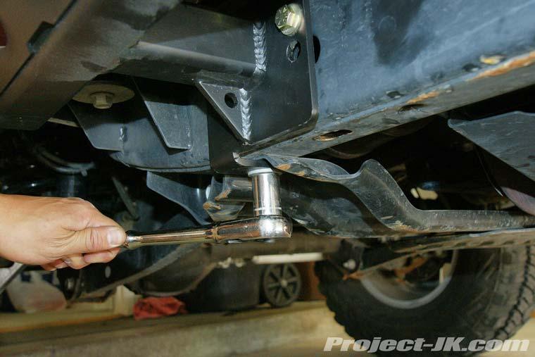 18. Using the factory hardware, secure your new LoD Signature Series Rock Slider to the points where the automatic transmisson and transfer case skid plates attach the frame rail on your Jeep JK