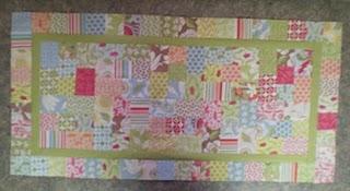 15. Runner should now measure 18 1/2" x 30 1/2". Layer runner top with batting and backing. Quilt as desired.