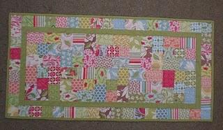 I also quilted two straight lines 1/4" away from the inner green border, and 5/8" from the outside edge of the runner (to accommodate for the binding). 16.
