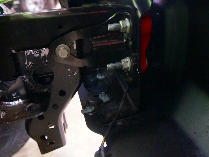 6. With the use of a 13mm socket, remove the front lower skid plate by removing the factory hardware that secures the skid