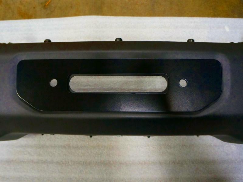 9. With the bumper facing upward, place the winch fairlead on top of the face plate