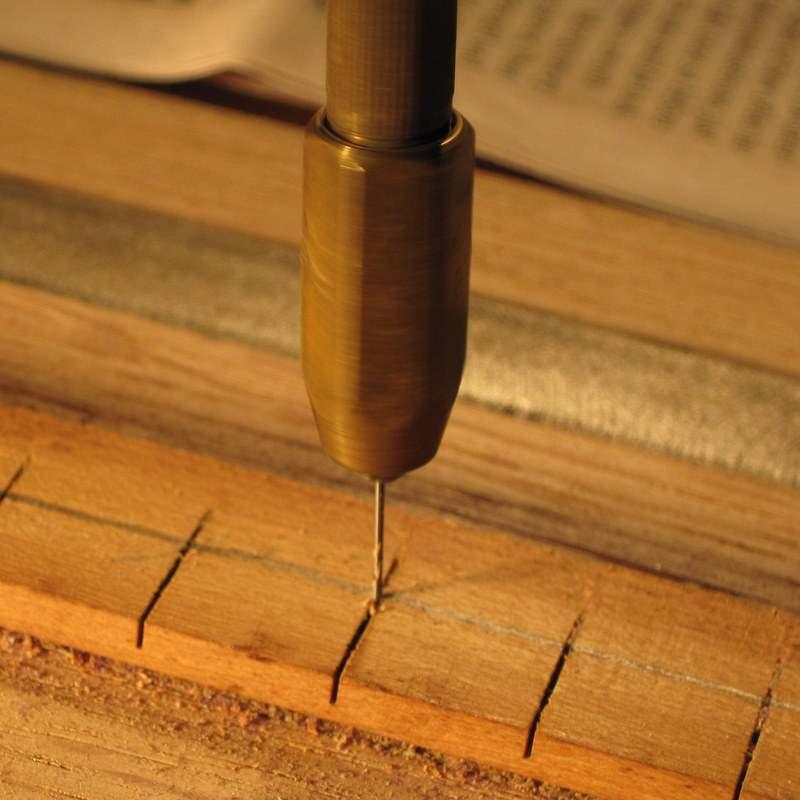 Step 16 : With the hammer spring rail held firmly in a vise, drill a hole at the back end of each spring slot.
