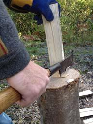 Straighten the wood so that it is held vertically on the chopping block.