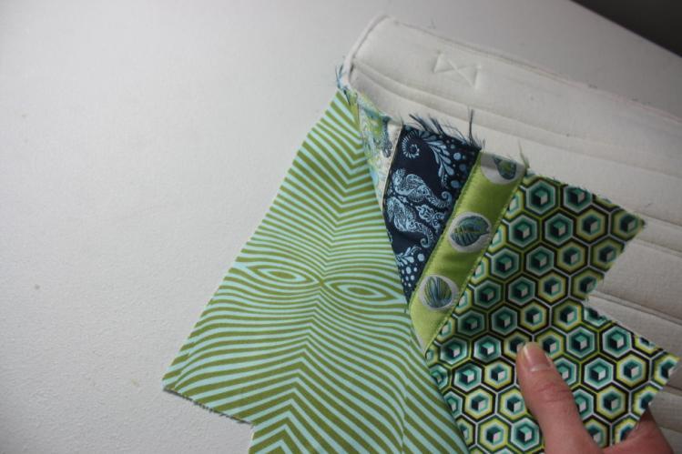 With your zipper foot on and using a 1/4" seam allowance from the top of the Exterior Main PAnel, stitch the zipper in place, including both zipper tabs. 25.