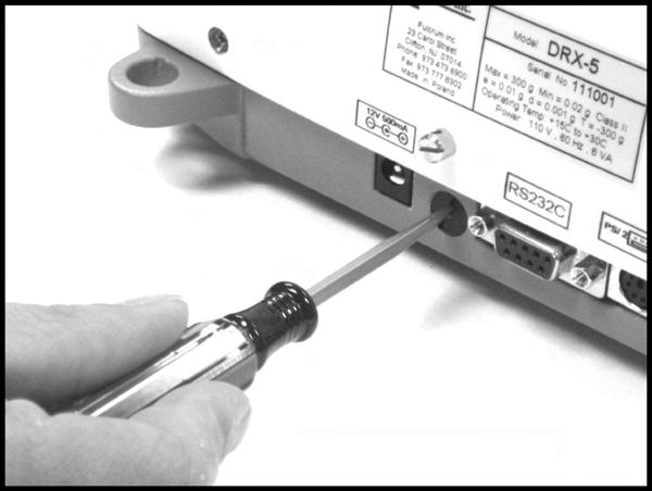 To seal the scale with a paper seal or a sticker, gently use a flathead screwdriver to remove the calibration wire seal screw located in the rear of the