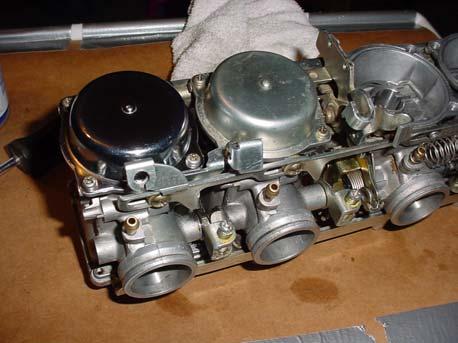 (Mine were allen socket screw heads, but I noticed from a picture of Mr. Fritz s carburetors, his were Philips head screws.) Now, on to the top side.