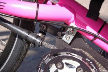 1) Align the chain guide tube so that the flexible attachment is horizontal and the bracket is vertical as on photo 12. 2) Tighten the nut and bolt holding the bracket extension to the motor plate.